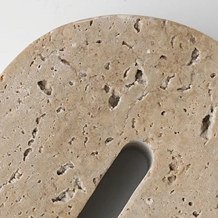 Top detail of handcrafted, arch shaped travertine book end