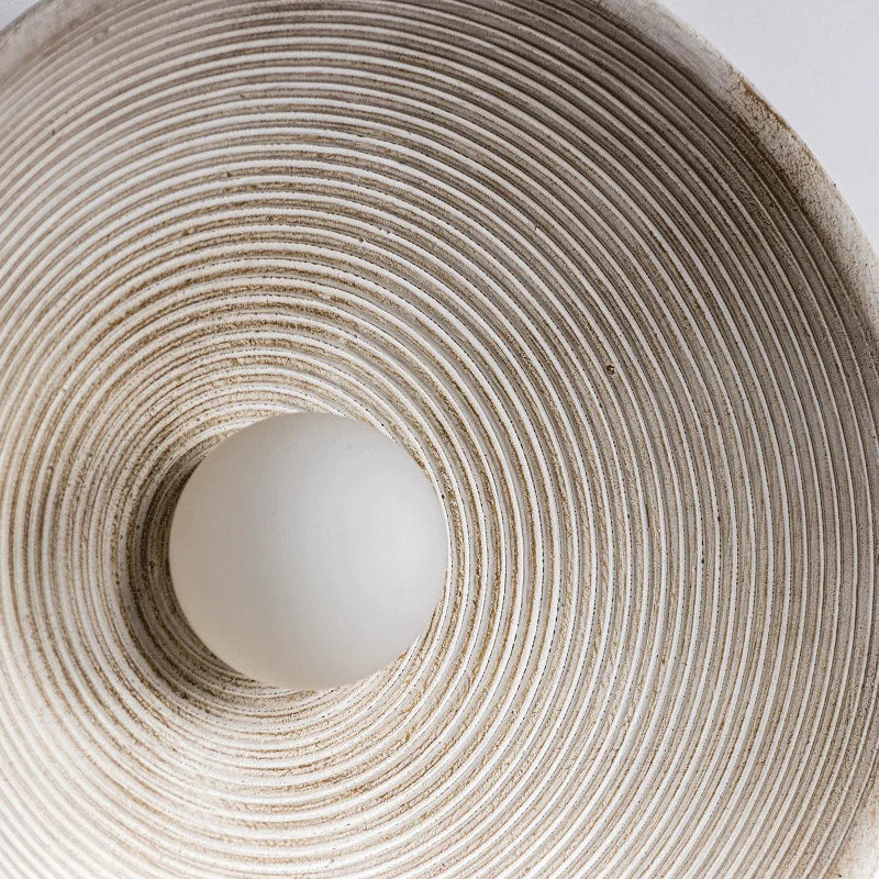 Detail of round Japandi wall lamp on neutral color background