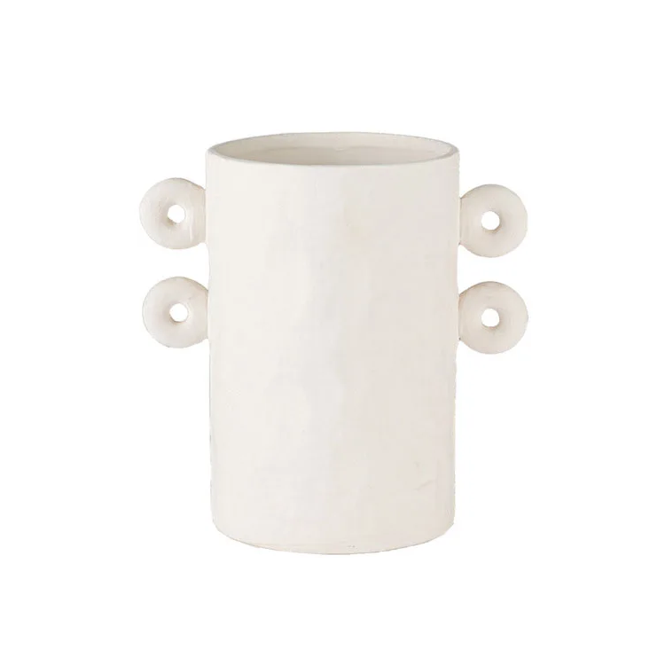 White textured ceramic planter with round details on sides, on white background