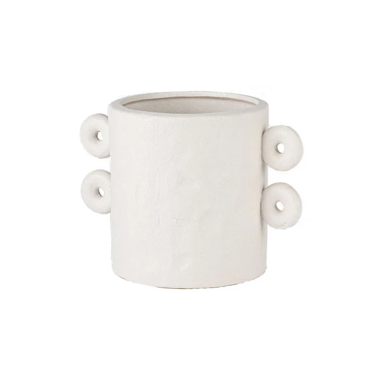 White textured ceramic planter with round details on sides, on white background