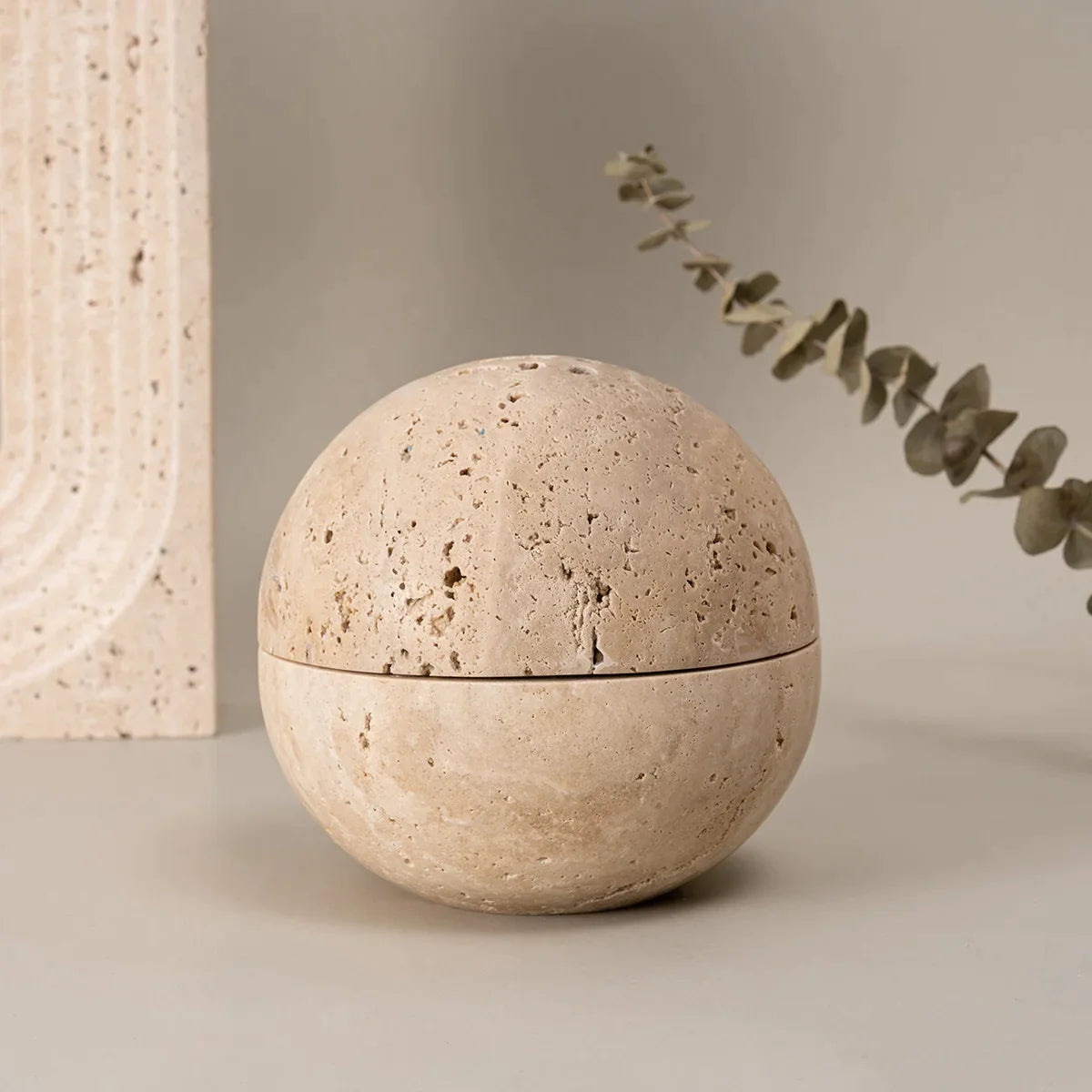 Spheric travertine stone incense burner on neutral background