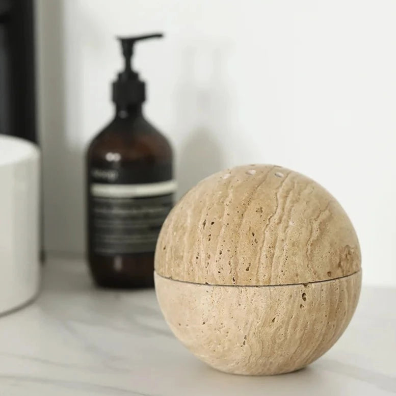 Spheric travertine stone incense burner in bathroom