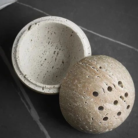 Top view of opened grey spheric travertine stone incense burner on neutral background