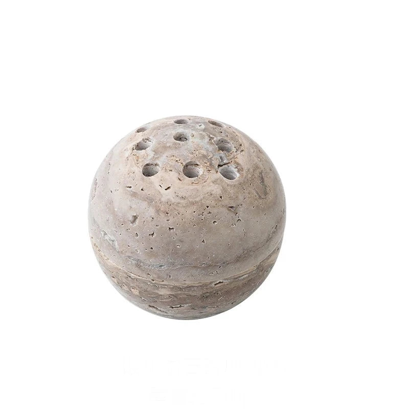 Spheric, grey travertine stone incense burner on white background