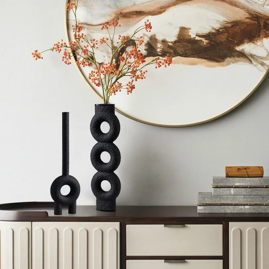 Set of two black  textured vases with circle design neck in elegant room