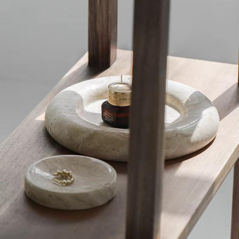 Round marble tray on wooden bookcase