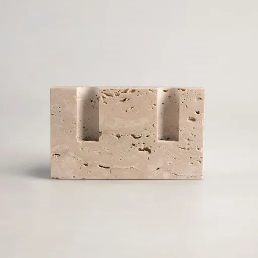 Rectangular travertine candlestick holder with smooth finish on light neutral background