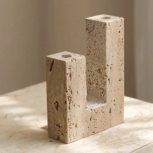 Handcrafted travertine candle holder on neutral background