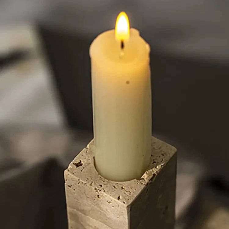 Candle inside handcrafted travertine candle holder