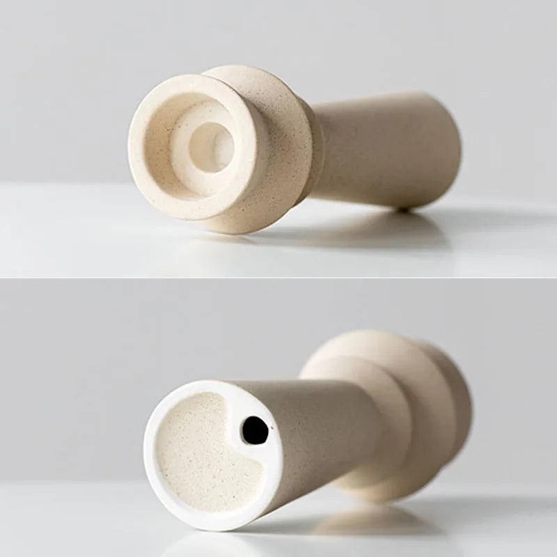 Details of white ceramic candle holder on light neutral background