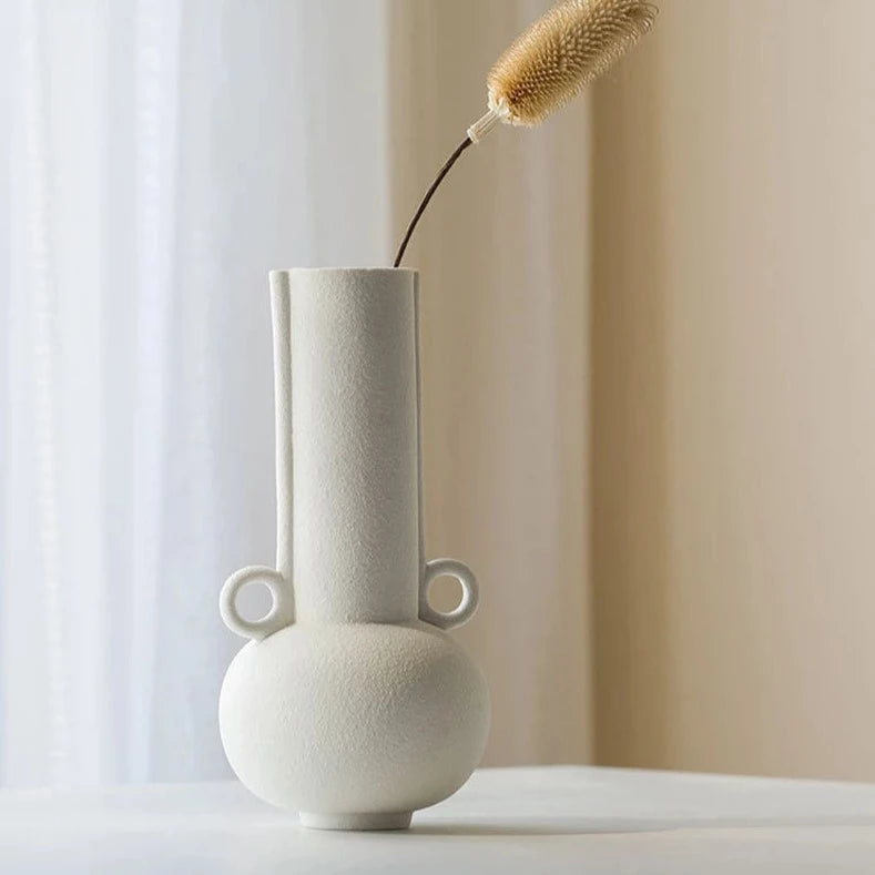 White textured vase with long neck on neutral room background
