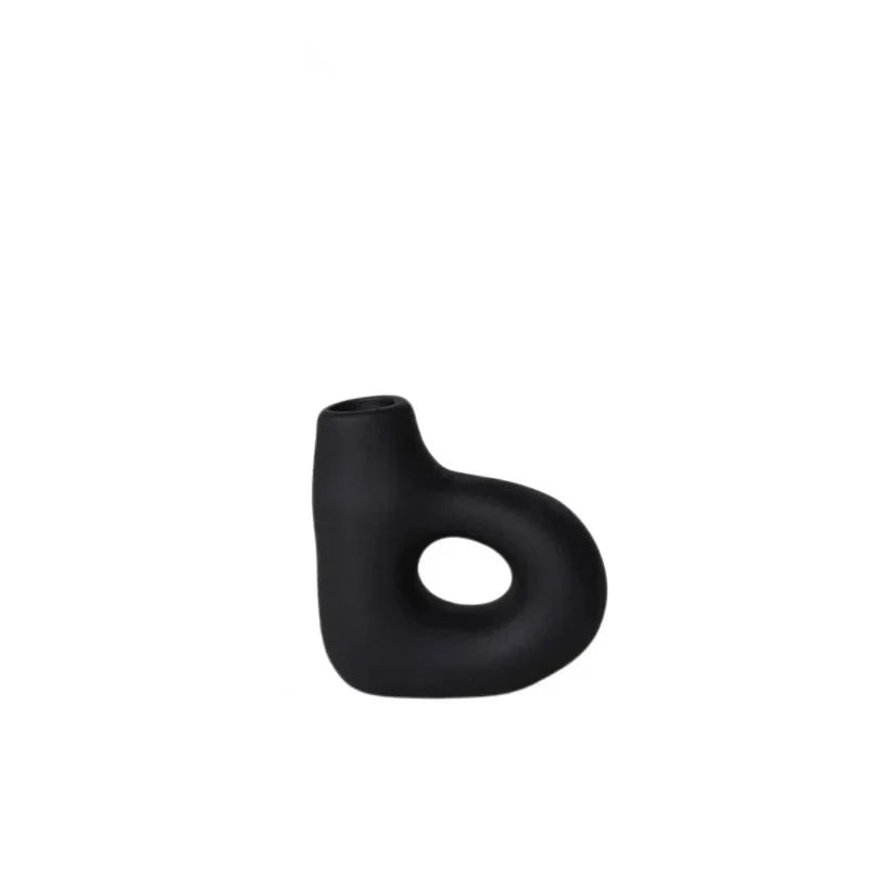 Organic shaped black ceramic candle holders on white background