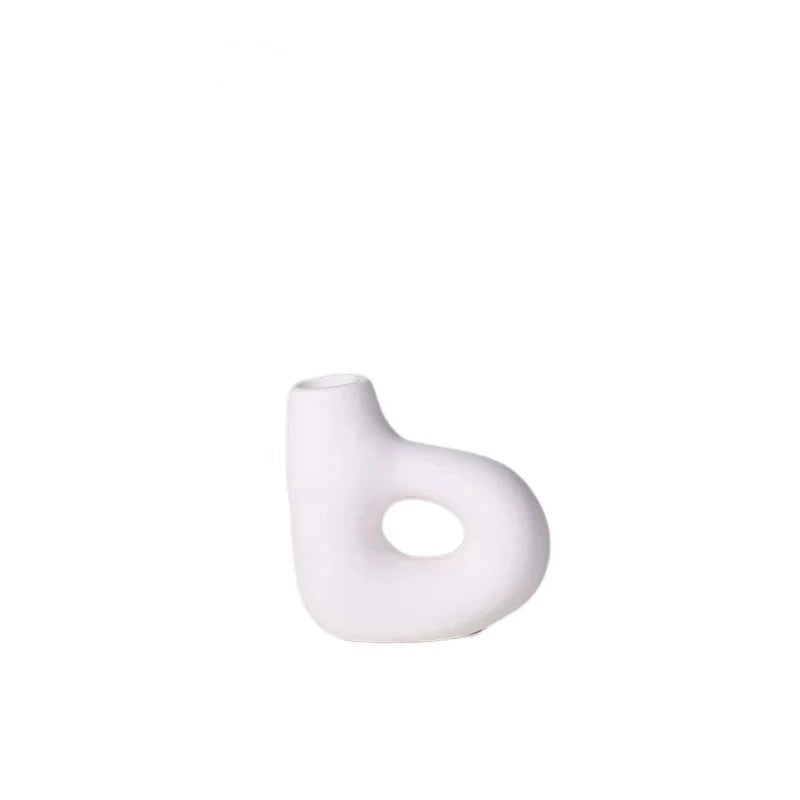 Organic shaped white ceramic candle holder on white background