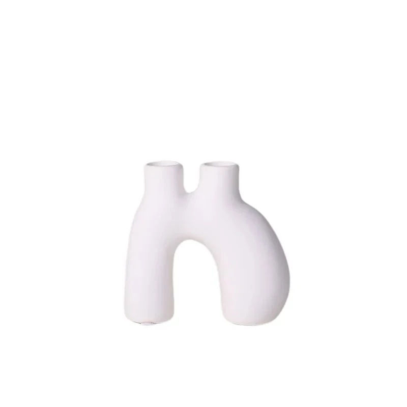 Organic shaped white ceramic candle holder on white background