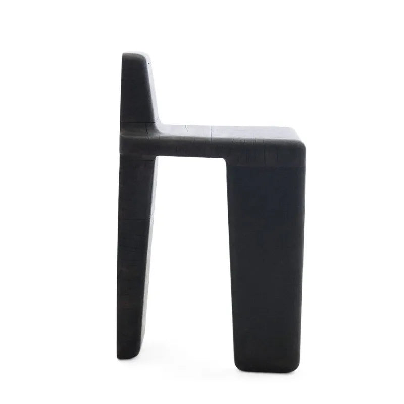 Profile view of black Japandi wood chair on white background