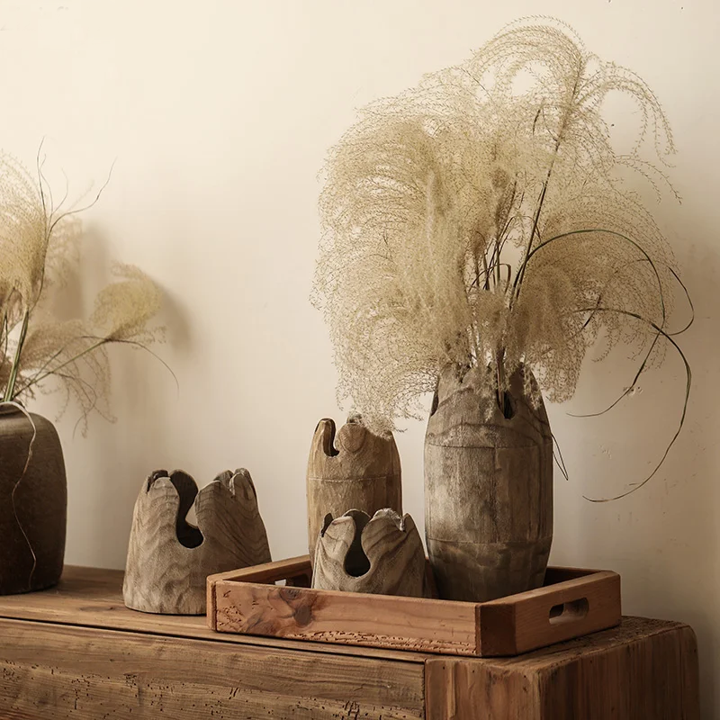 Set of four handcrafted japandi wooden vases with pampa plant, on wood cabinet and neutral background