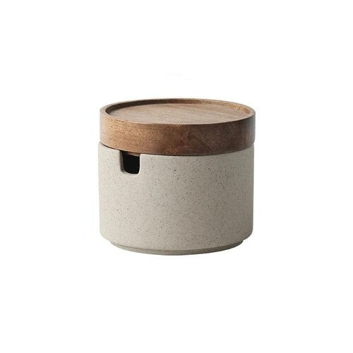 Single grey ceramic spice jar with wooden lid on white background