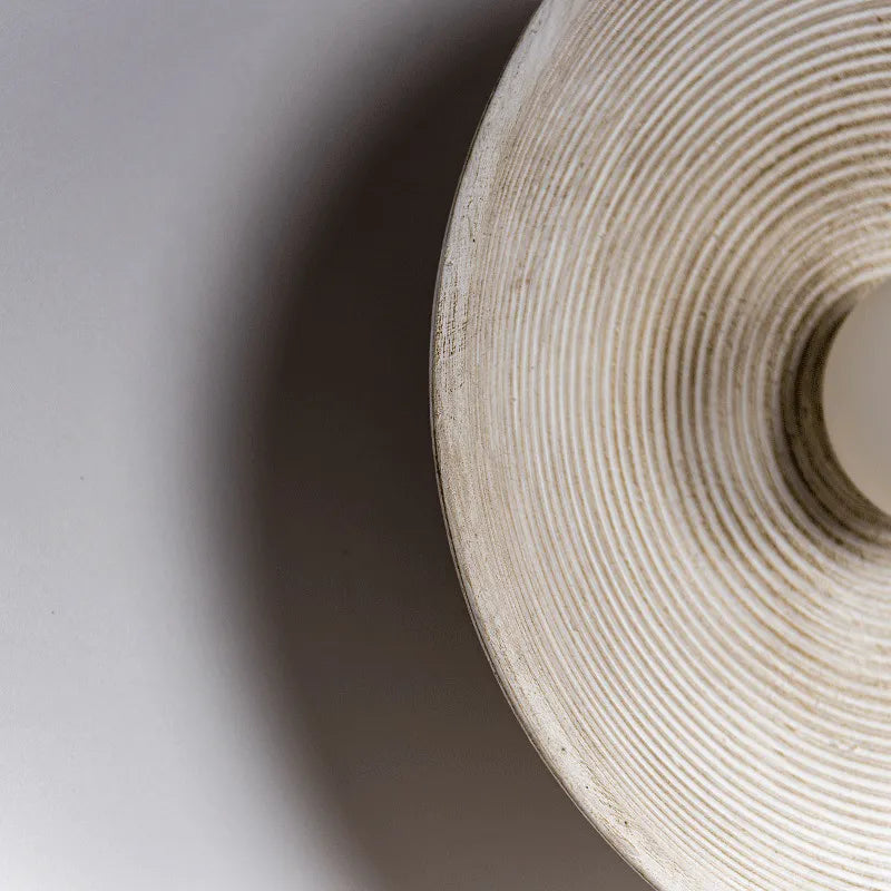 Detail of round Japandi wall lamp on neutral color background