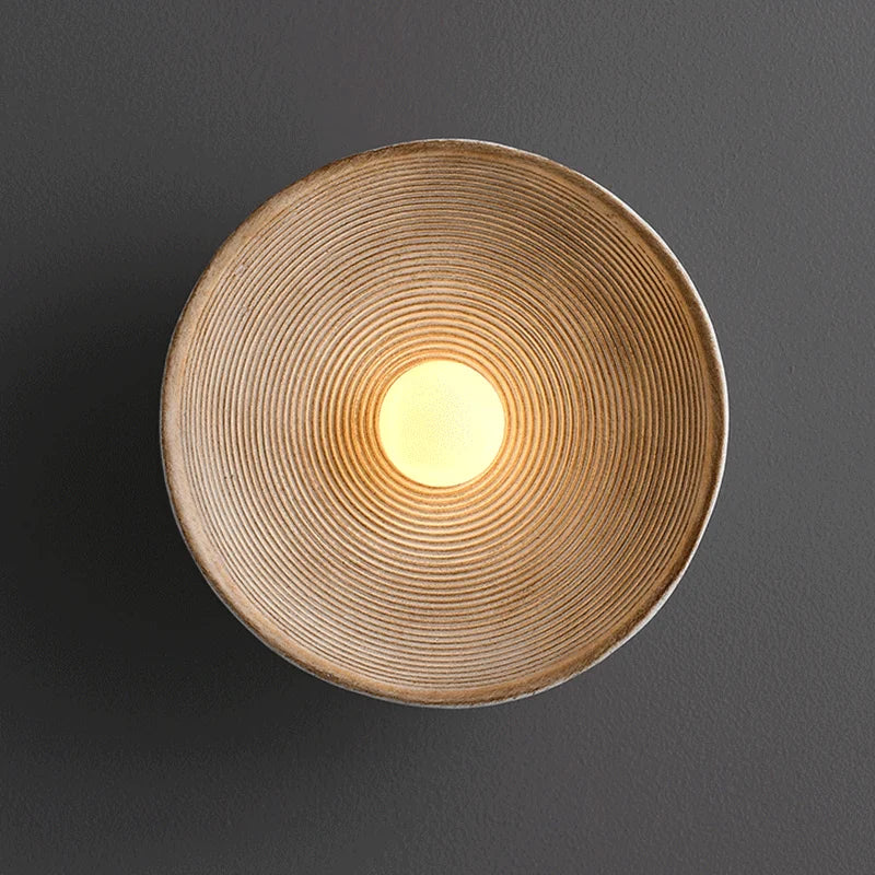 Detail of round Japandi wall lamp on neutral color background