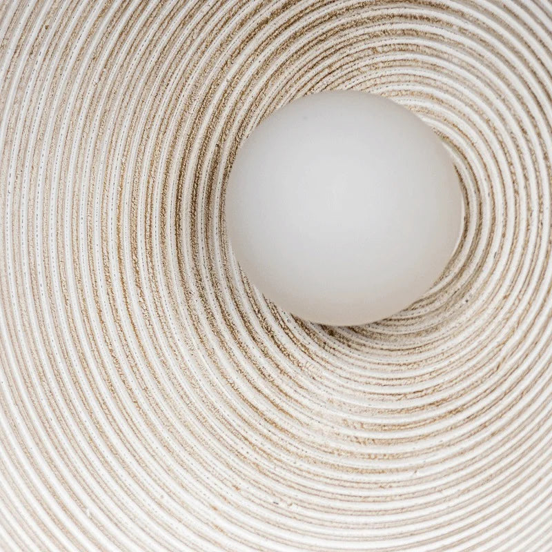 Detail of round Japandi wall lamp on neutral color background