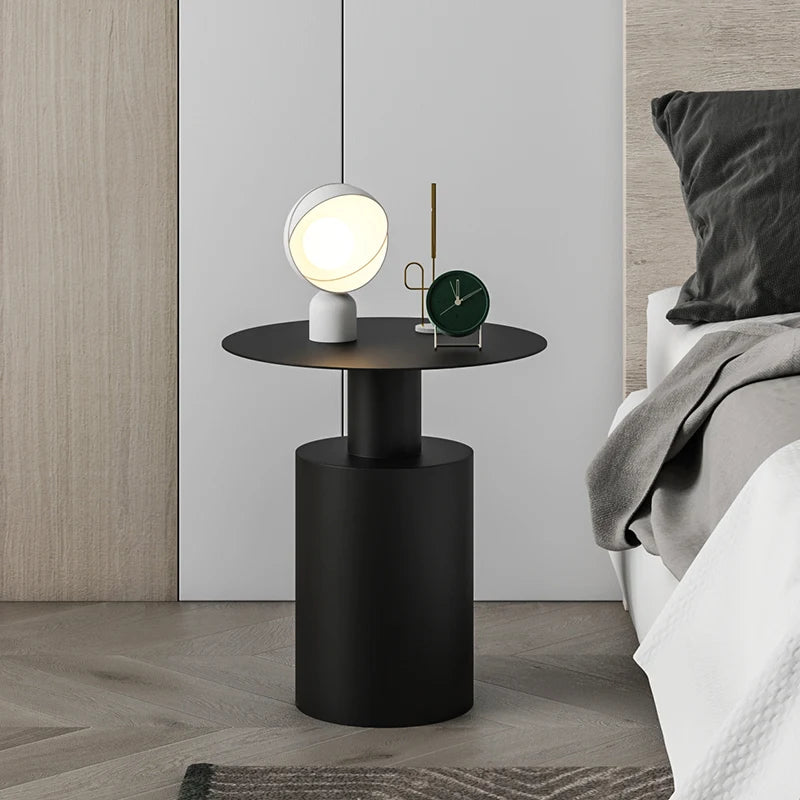 Sleek black lightweight metal side table in minimalist bedroom