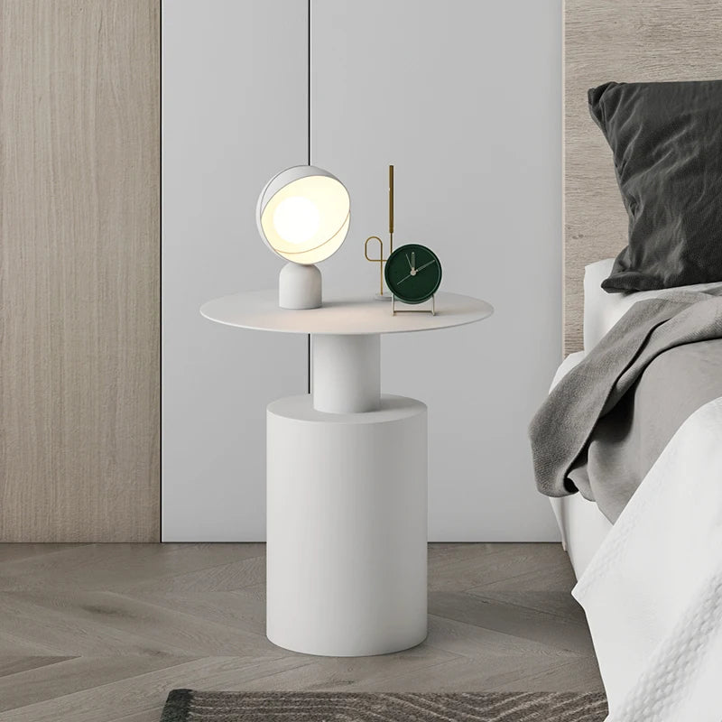 Sleek white lightweight metal side table in minimalist bedroom