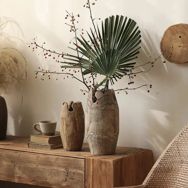 Set of two handcrafted japandi wooden vases with plants on wood cabinet and neutral japandi background