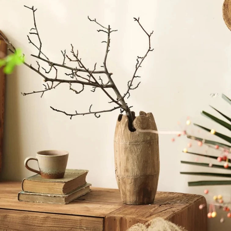 Handcrafted japandi wooden vase with branch and books, on wood cabinet and neutral japandi background