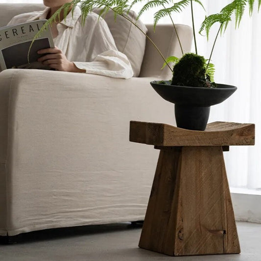 Handcrafted japandi wooden side table with black vase and plant in japandi living room