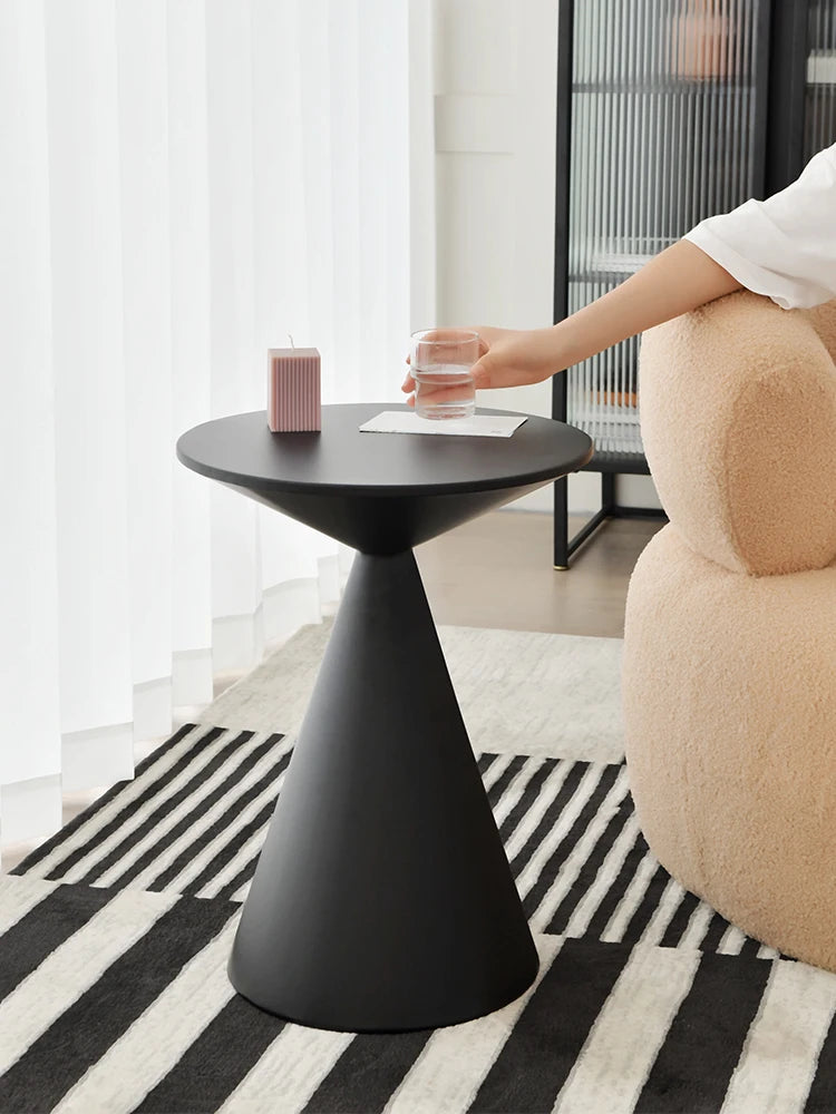 Sleek black lightweight metal side table in minimalist living room