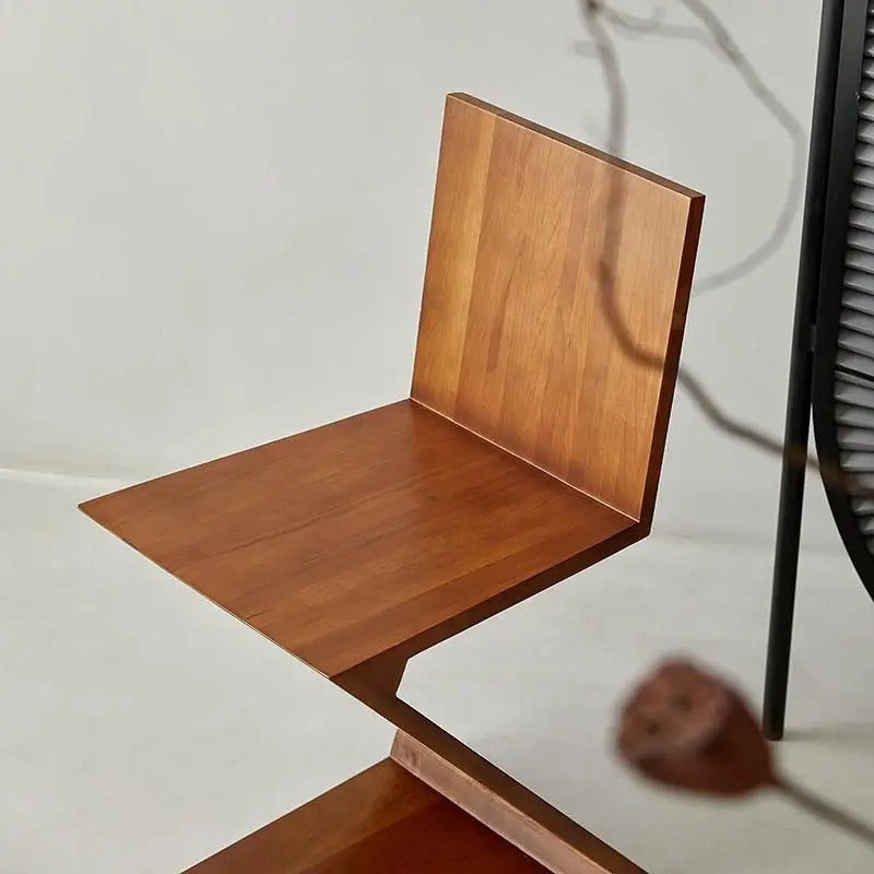 Brown zeta shaped wooden chair in neutral room