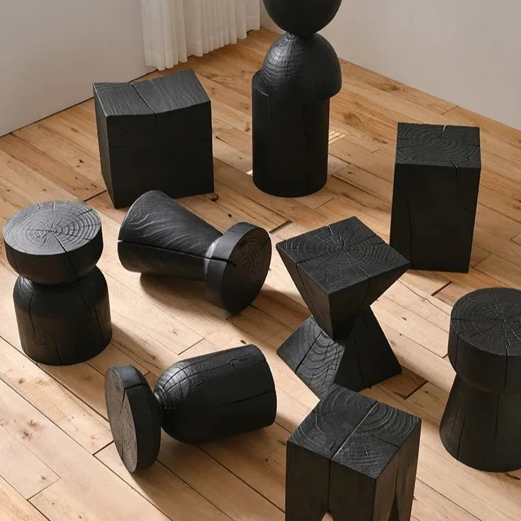 Elevated view of many wooden tables in different shapes, with black finish